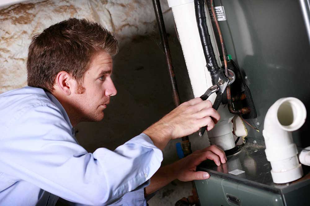 Man working on furnace